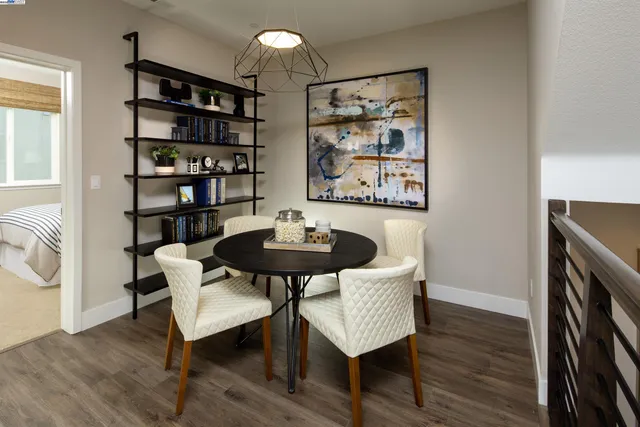 a spacious bedroom with a bed a chandelier and a desk