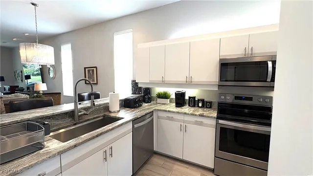 a kitchen with a sink stove and microwave