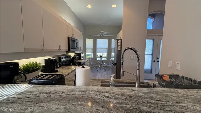 a kitchen with sink a refrigerator and cabinets