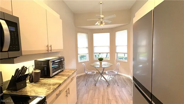 a view of a dining room with furniture a chandelier and wooden floor