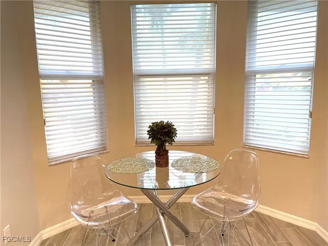 a dining room with table and chairs