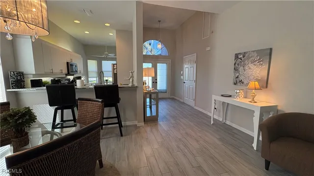 a view of a dining room with furniture wooden floor and a chandelier
