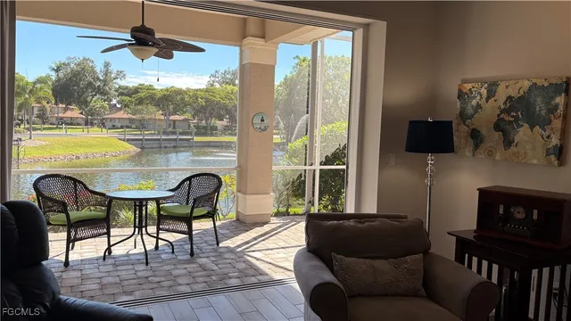 a living room with furniture and a floor to ceiling window