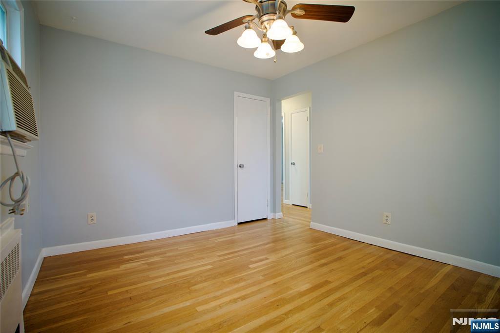 524 Studio Road, Unit 1 Ridgefield, NJ 07657 - Photo 11 of 44 a view of an empty room with a chandelier fan