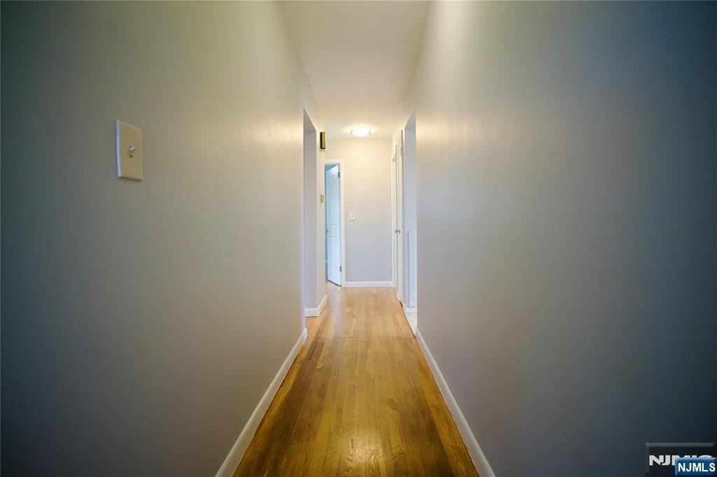 524 Studio Road, Unit 1 Ridgefield, NJ 07657 - Photo 12 of 44 a view of a hallway with wooden floor