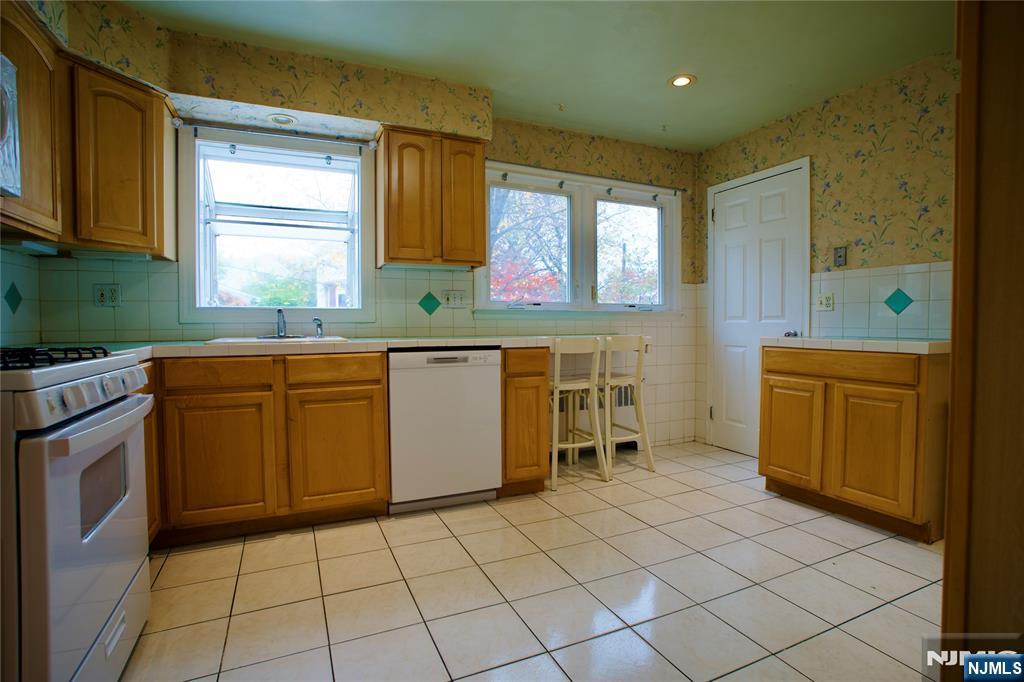 524 Studio Road, Unit 1 Ridgefield, NJ 07657 - Photo 13 of 44 a kitchen with a sink window and cabinets