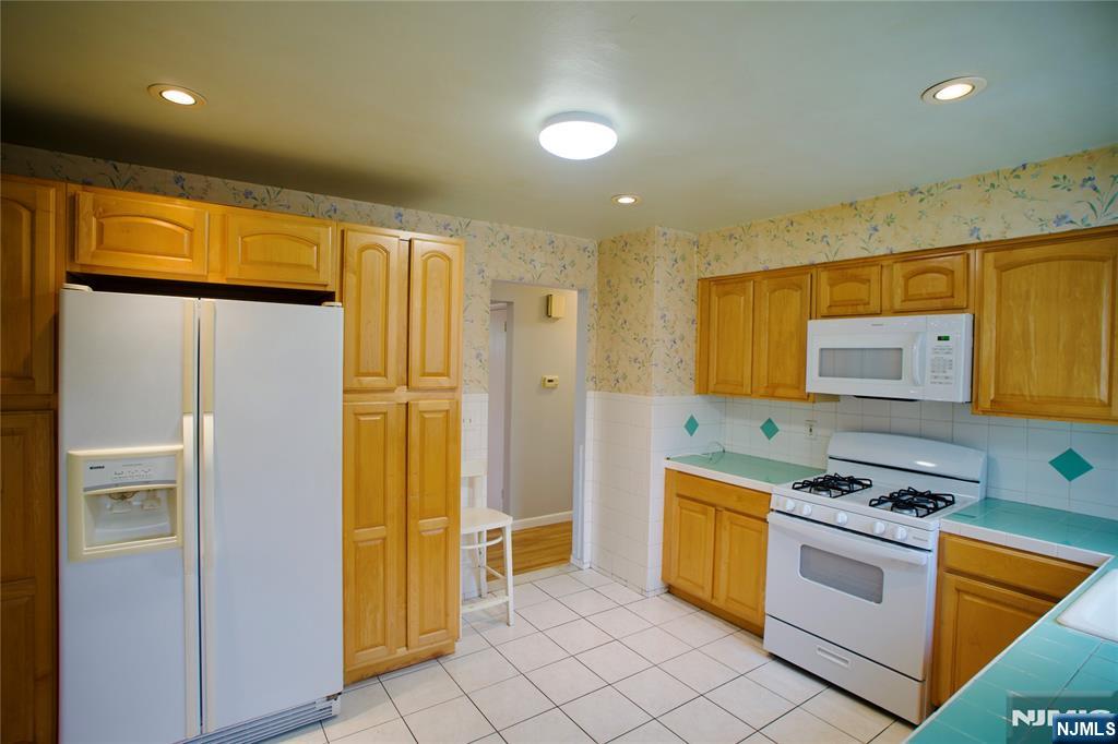 524 Studio Road, Unit 1 Ridgefield, NJ 07657 - Photo 21 of 44 a kitchen with stainless steel appliances granite countertop a stove a refrigerator and a refrigerator