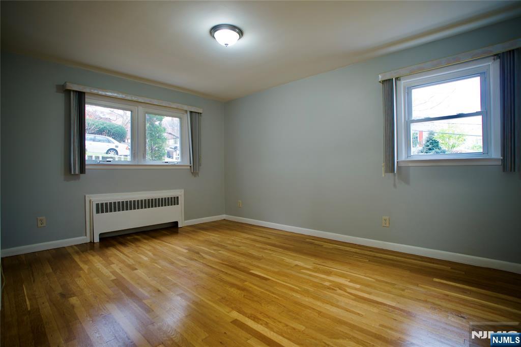 524 Studio Road, Unit 1 Ridgefield, NJ 07657 - Photo 22 of 44 a view of an empty room with wooden floor and a window