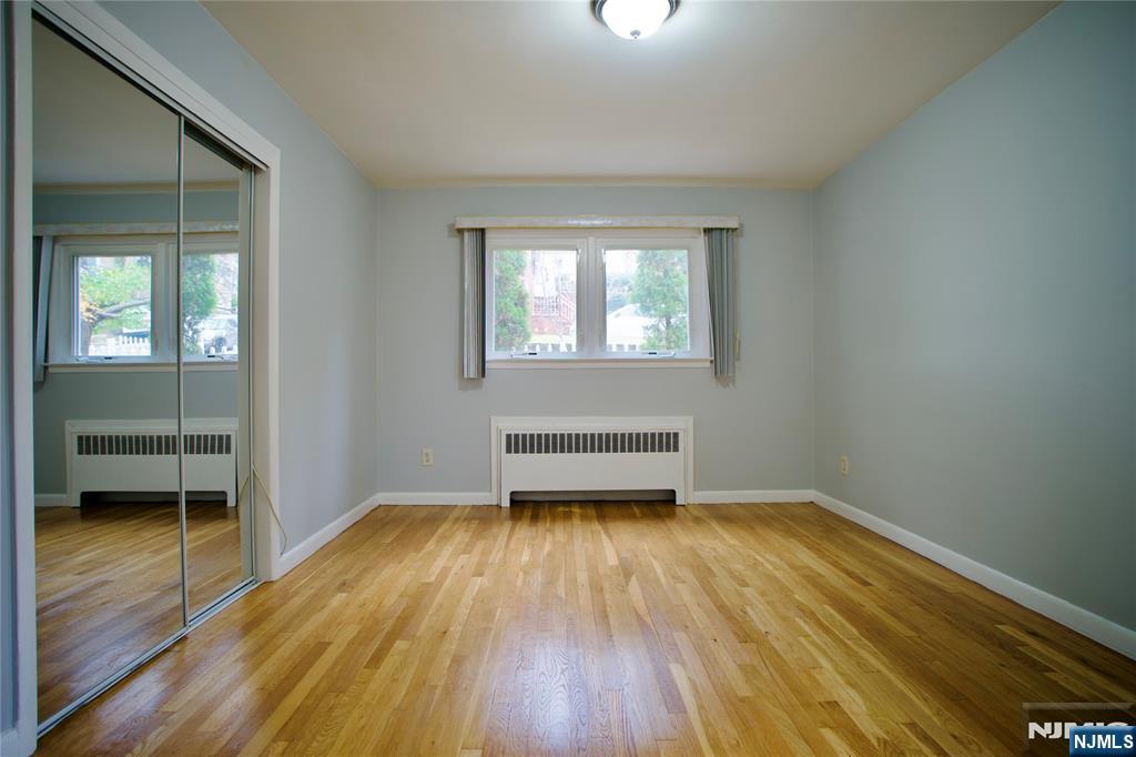 524 Studio Road, Unit 1 Ridgefield, NJ 07657 - Photo 25 of 44 wooden floor in an empty room with a window