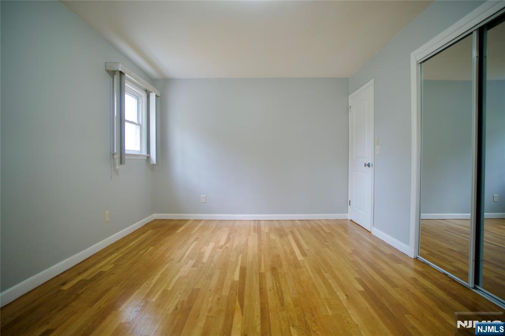 524 Studio Road, Unit 1 Ridgefield, NJ 07657 - Photo 27 of 44 a view of empty room with wooden floor and fan
