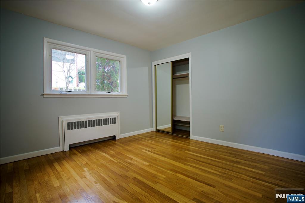 524 Studio Road, Unit 1 Ridgefield, NJ 07657 - Photo 29 of 44 a view of an empty room with wooden floor and a window