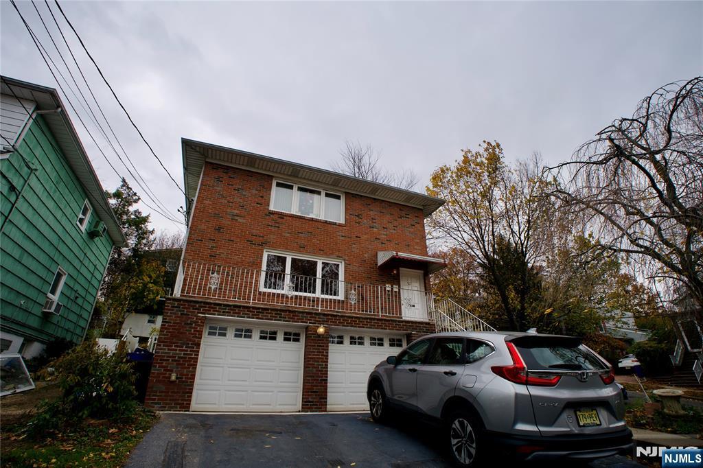 524 Studio Road, Unit 1 Ridgefield, NJ 07657 - Photo 3 of 44 a front view of a house with a yard