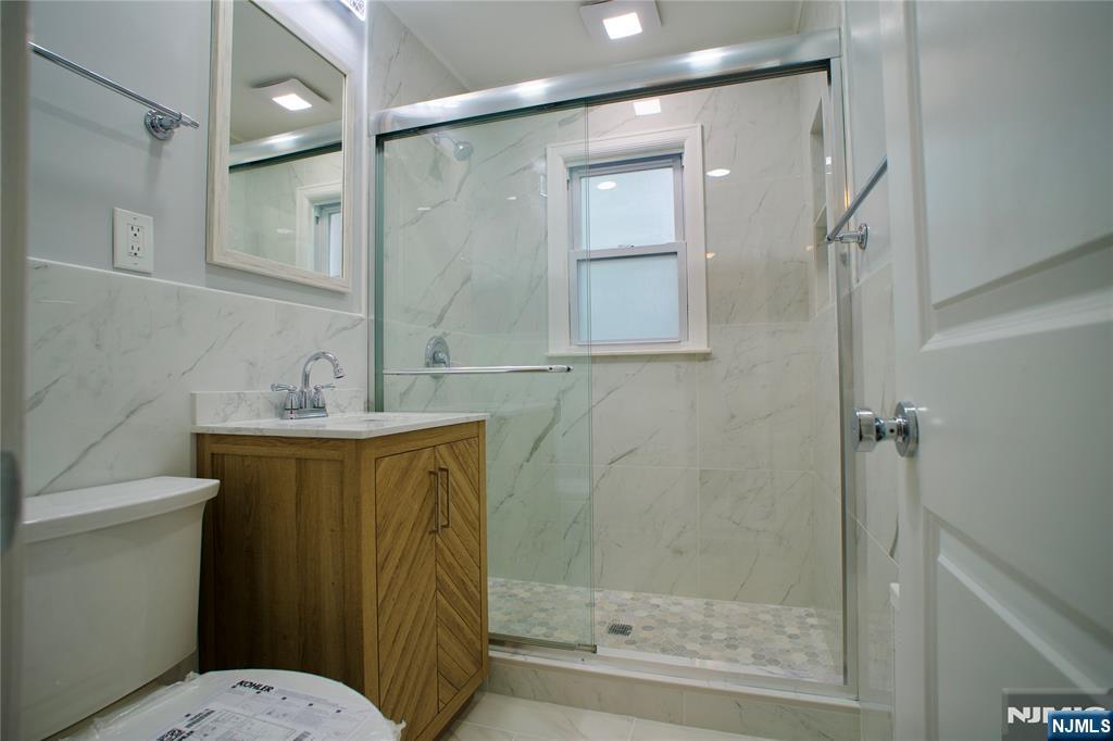 524 Studio Road, Unit 1 Ridgefield, NJ 07657 - Photo 31 of 44 a bathroom with a granite countertop sink toilet and shower