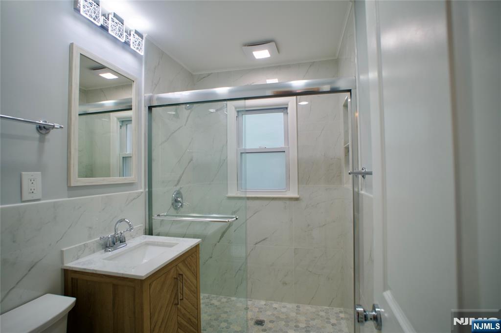 524 Studio Road, Unit 1 Ridgefield, NJ 07657 - Photo 32 of 44 a bathroom with a sink vanity and shower