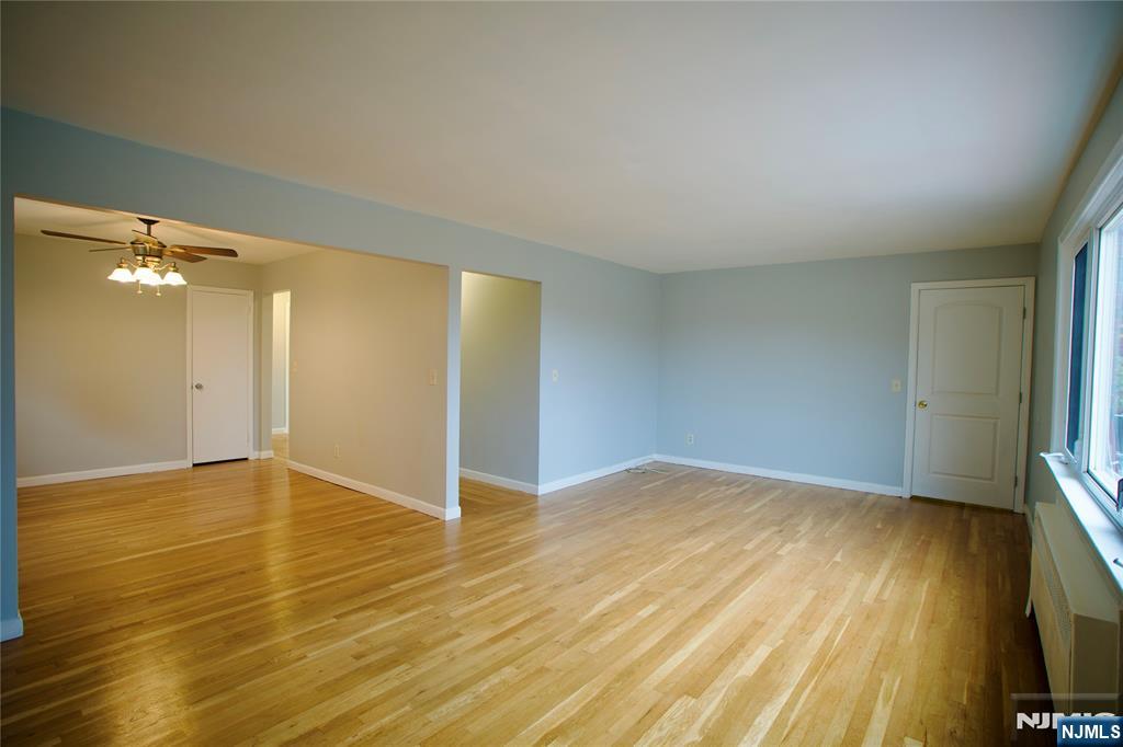524 Studio Road, Unit 1 Ridgefield, NJ 07657 - Photo 37 of 44 a view of an empty room with wooden floor and a flat screen tv