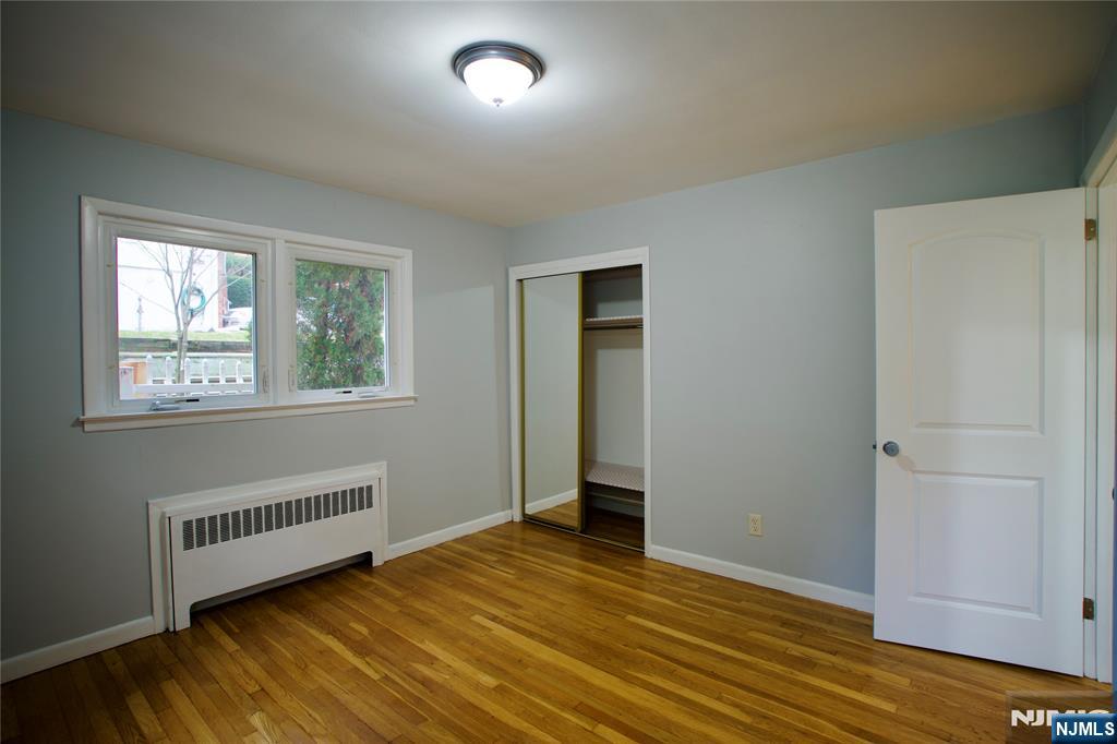 524 Studio Road, Unit 1 Ridgefield, NJ 07657 - Photo 40 of 44 a view of an empty room with wooden floor and a window