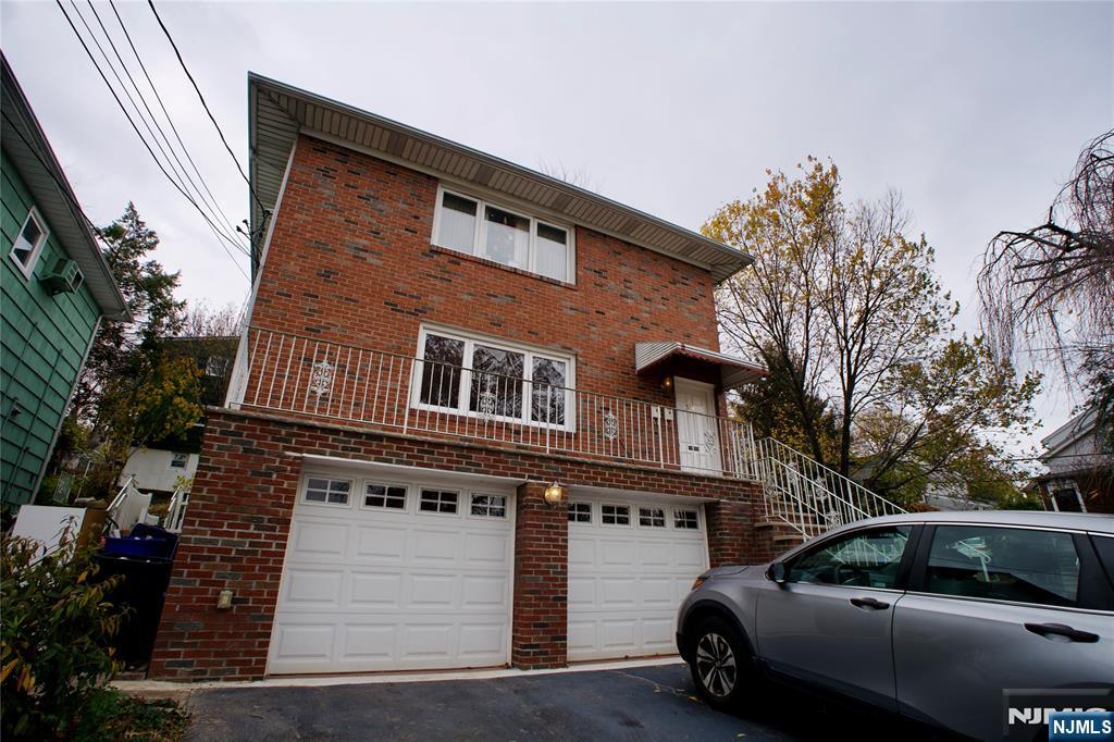 524 Studio Road, Unit 1 Ridgefield, NJ 07657 - Photo 4 of 44 a car parked in front of a house