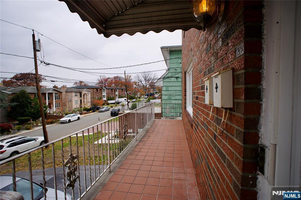 524 Studio Road, Unit 1 Ridgefield, NJ 07657 - Photo 41 of 44 a view of a balcony with wooden floor