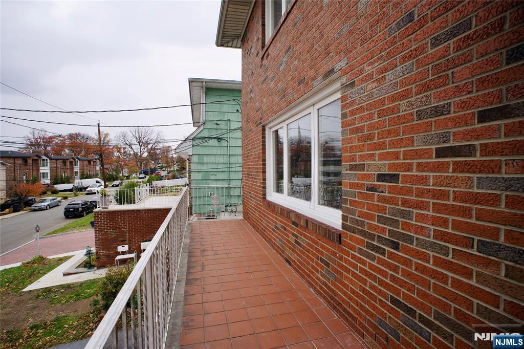 524 Studio Road, Unit 1 Ridgefield, NJ 07657 - Photo 42 of 44 a view of a balcony with wooden floor and outdoor space