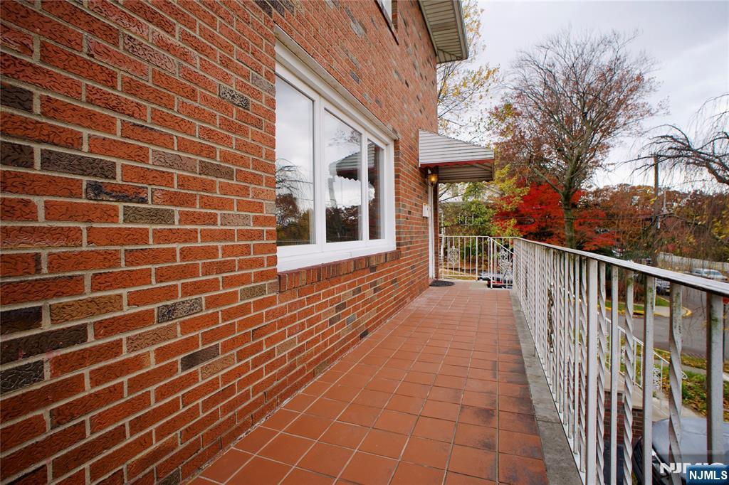 524 Studio Road, Unit 1 Ridgefield, NJ 07657 - Photo 43 of 44 a view of a brick house with a large window