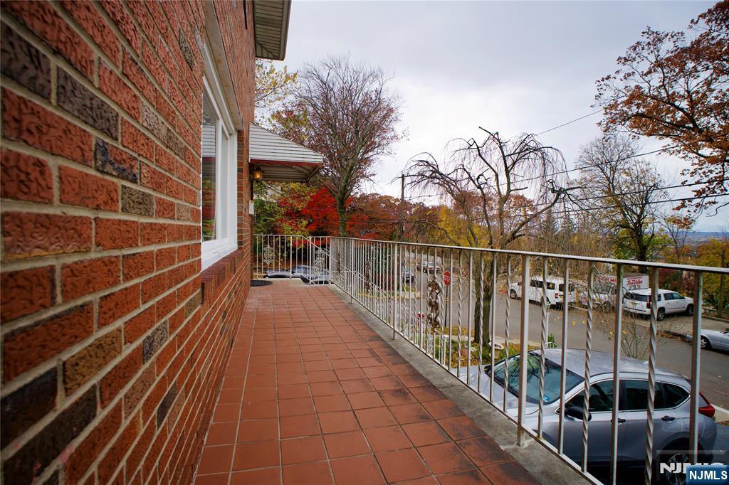524 Studio Road, Unit 1 Ridgefield, NJ 07657 - Photo 44 of 44 a view of balcony with wooden floor and fence and a potted plant