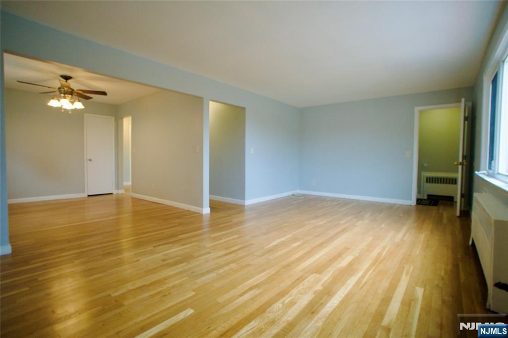 524 Studio Road, Unit 1 Ridgefield, NJ 07657 - Photo 7 of 44 a view of a room with wooden floor and a ceiling fan