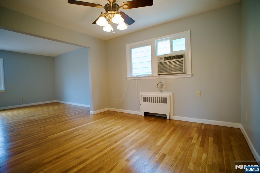 524 Studio Road, Unit 1 Ridgefield, NJ 07657 - Photo 10 of 44 a view of a livingroom with wooden floor and a ceiling fan