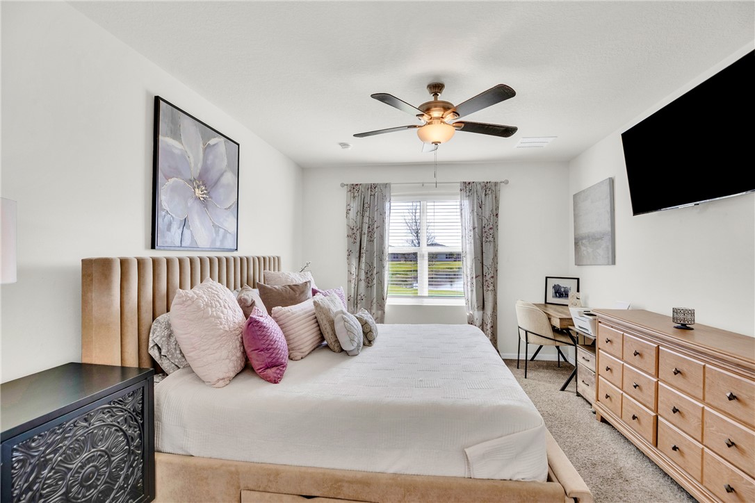3453 Trinity Circle Fort Pierce, FL 34945 - Photo 15 of 36 a bed room with a bed a television and a couch