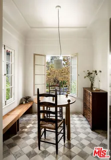 a dining room with furniture and window