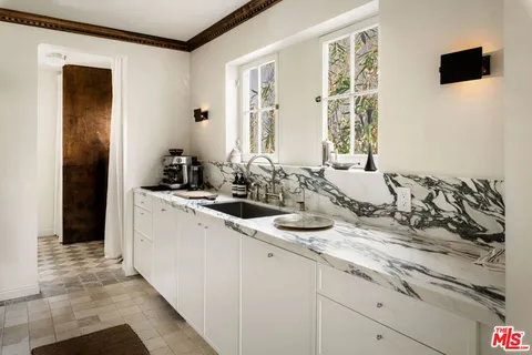 a room with sink and mirror