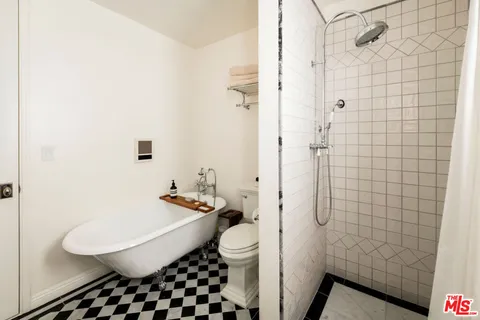 a bathroom with a sink a toilet and shower curtain