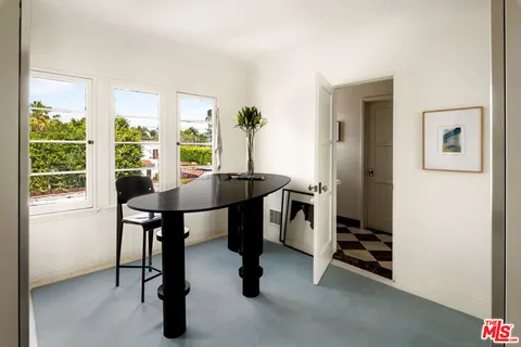 a view of a livingroom with furniture and a window