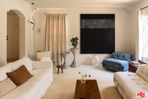 a bedroom with furniture and a flat screen tv