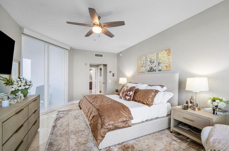 4600 North Ocean Drive, Unit 1603 Singer Island, FL 33404 - Photo 11 of 43 a bedroom with a bed chandelier and a window
