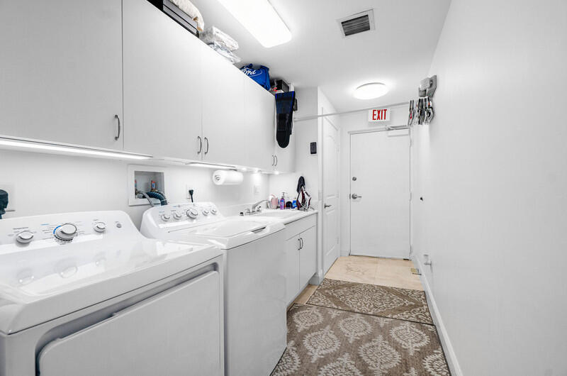 4600 North Ocean Drive, Unit 1603 Singer Island, FL 33404 - Photo 22 of 43 a kitchen with kitchen island a sink stainless steel appliances and cabinets