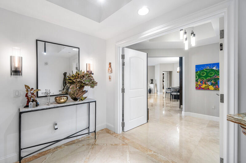 4600 North Ocean Drive, Unit 1603 Singer Island, FL 33404 - Photo 3 of 43 a view of a hallway view with two mirror and a potted plant