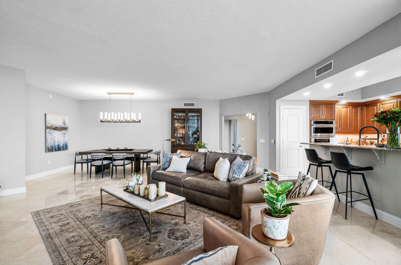 4600 North Ocean Drive, Unit 1603 Singer Island, FL 33404 - Photo 8 of 43 a living room with furniture and a potted plant