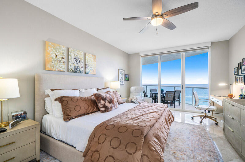 4600 North Ocean Drive, Unit 1603 Singer Island, FL 33404 - Photo 10 of 43 a bedroom with a bed a large window with the outer view