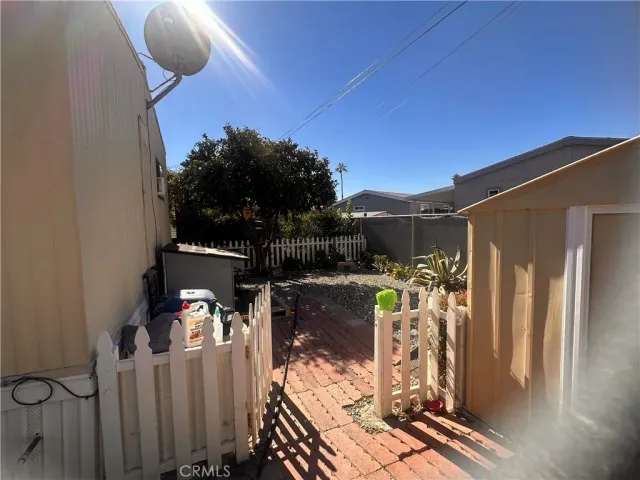 a view of a balcony with chairs and potted plants