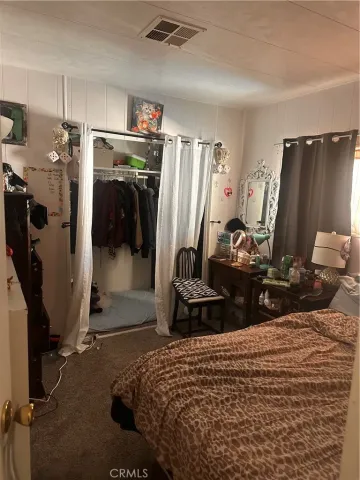 a bedroom with bed and a closet