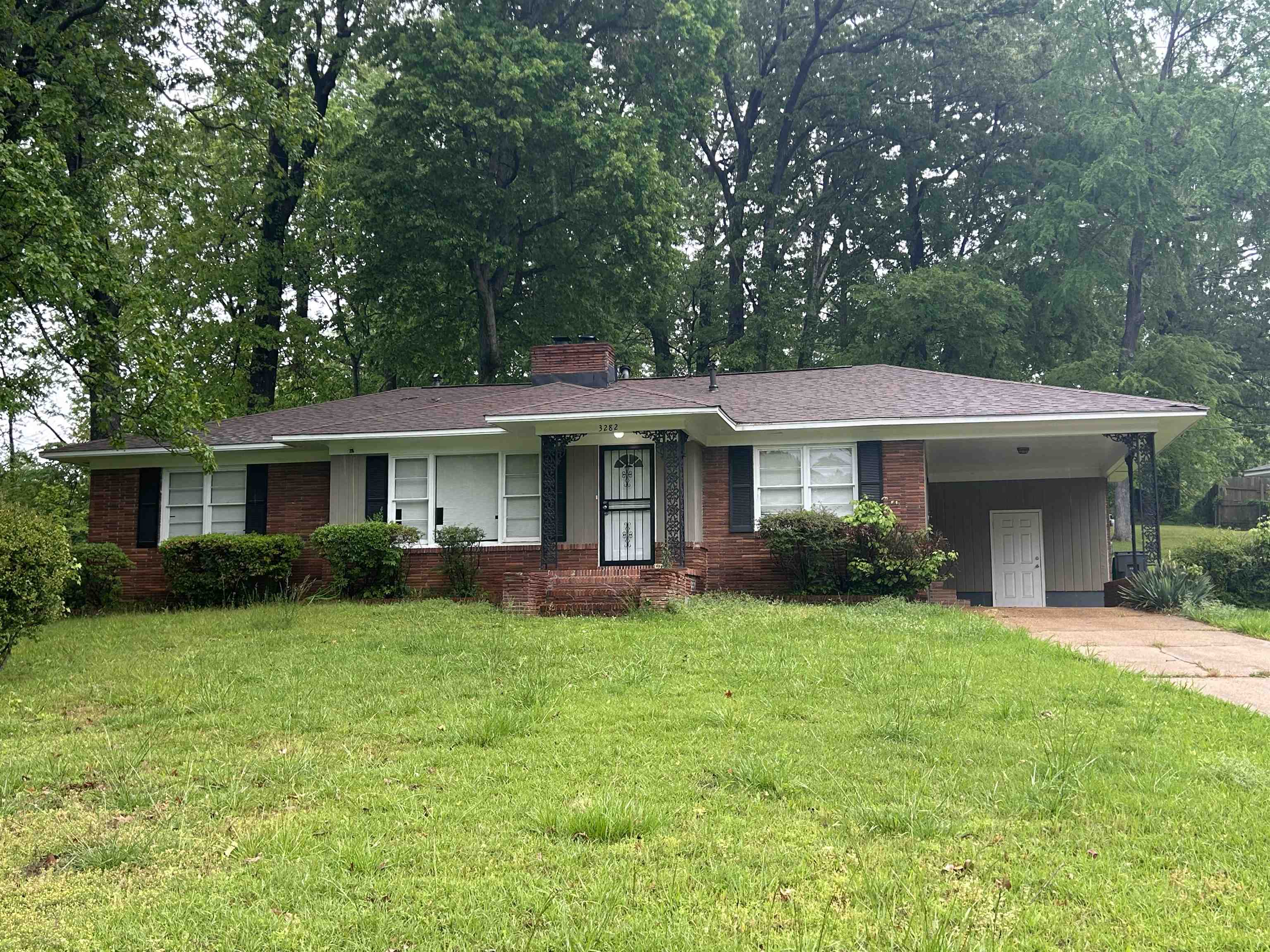 3282 Rickey Road Memphis, TN 38128 - Photo 1 of 4 a front view of a house with a garden