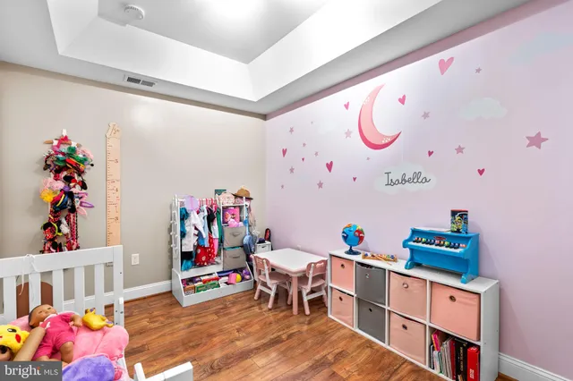 a living room with furniture and a baby crib