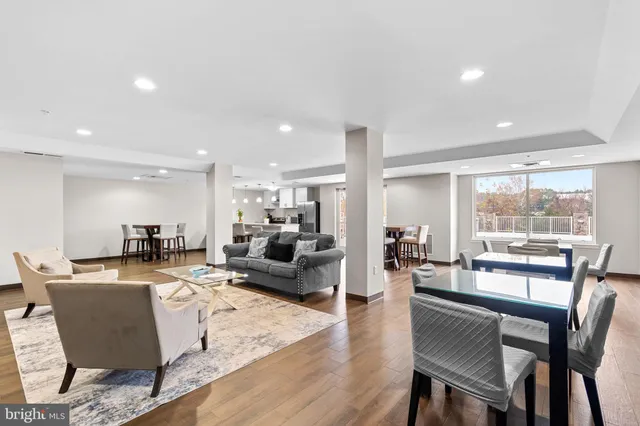 a living room with fireplace furniture and a large window