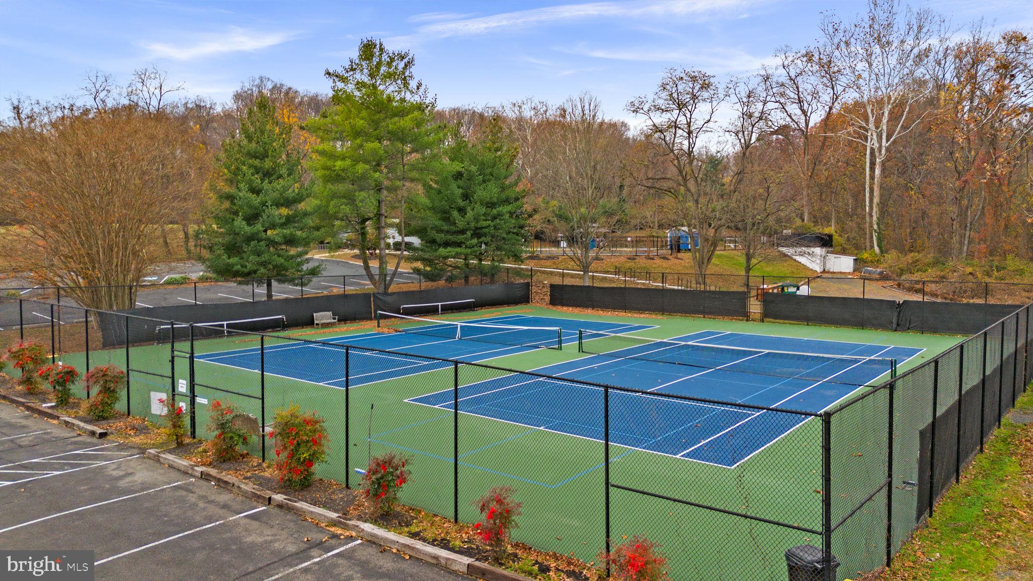 6301 Edsall Road, Unit 500 Alexandria, VA 22312 - Photo 26 of 30 a view of a tennis ground with large trees