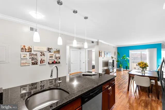 a kitchen with granite countertop a sink and cabinets