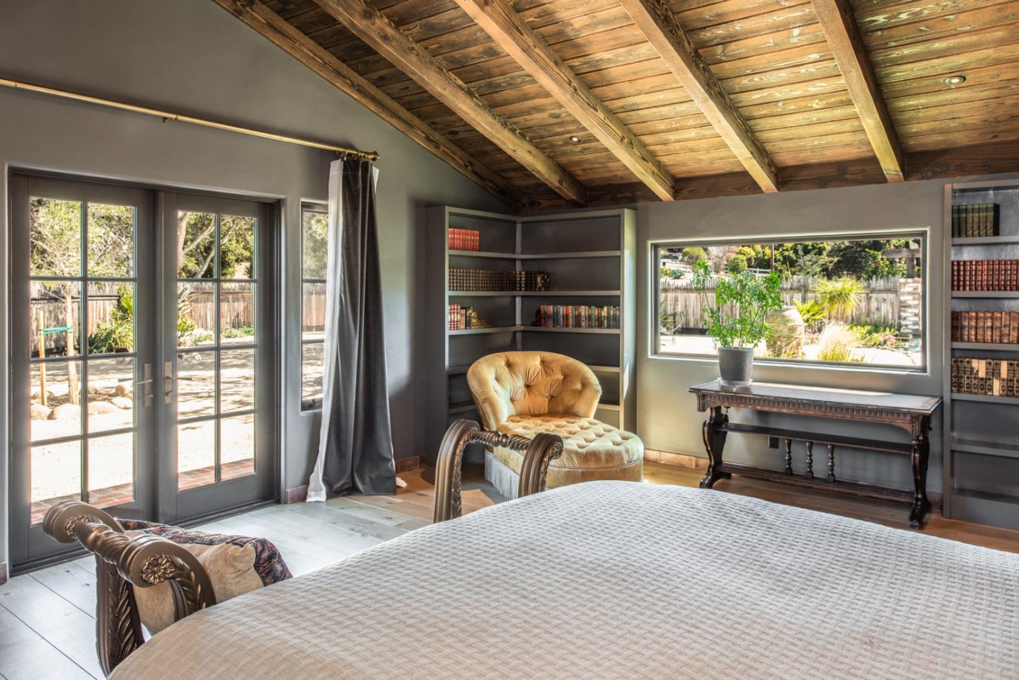 34 Rancho Road Carmel Valley, CA 93924 - Photo 14 of 22 a bedroom with a bed and large windows