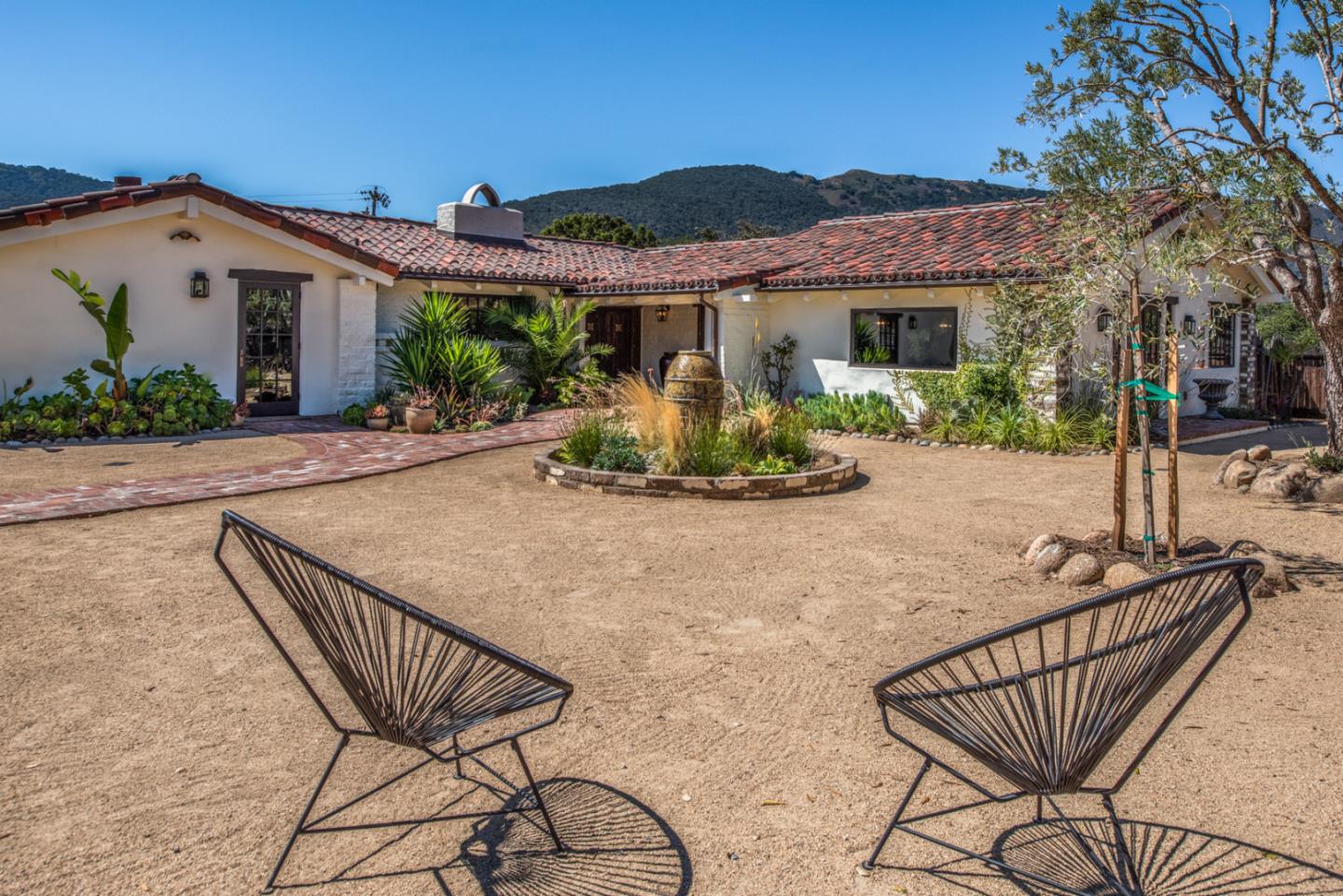 34 Rancho Road Carmel Valley, CA 93924 - Photo 19 of 22 a view of a chair and table in the patio