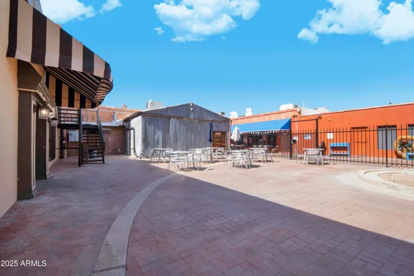 a view of a house with a patio and a yard