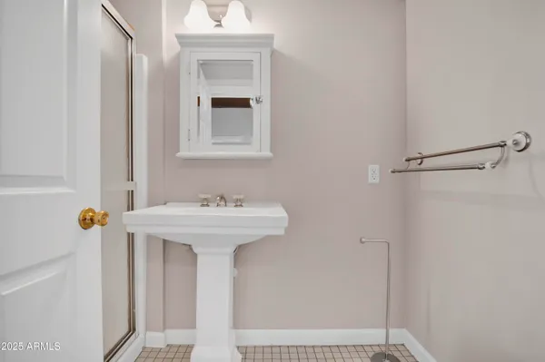 a bathroom with a sink a mirror and shower