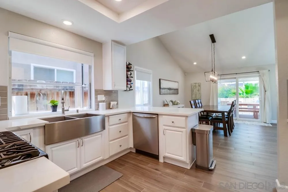 10544 Cadwell Road Santee, CA 92071 - Photo 8 of 27 a large kitchen with kitchen island a sink table and chairs